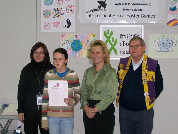 Winner of the Fredericton Lions Club 2007 Peace Poster Contest, Rebakah Godin. L-R Lisa Shorthall, Senior Program Director Fredericton Boy & Girls Club; Rebakah, Kelly Waugh, Operations Manager Brookside Mall and Fredericton Lions Club President Karl Bowland. 