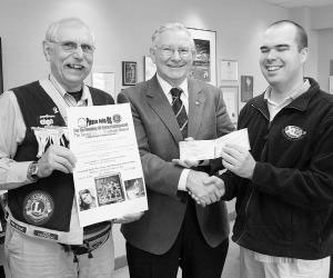 Moncton Mayor Lorne Mitton, centre, receives a pair of tickets from Shilo Bellis of XL96 for the second annual Blindfold Dinner to be held next Thursday at the Moncton High School Auditorium. 